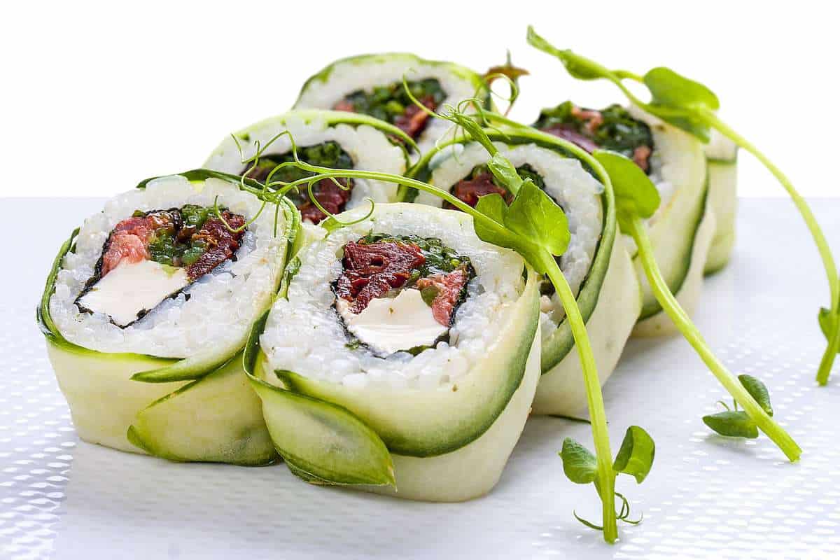 Vegan Sushi, plant-based sushi with tofu, tomato courgette and leafy greens