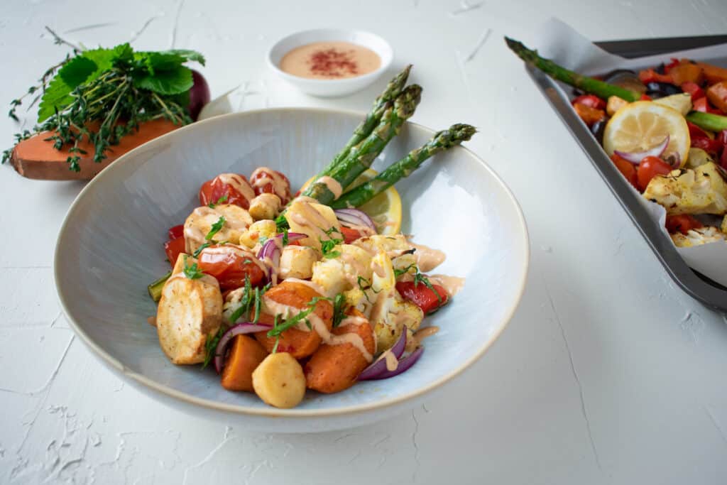 Vegan tray bake with seasonable veggies and and tahini sauce