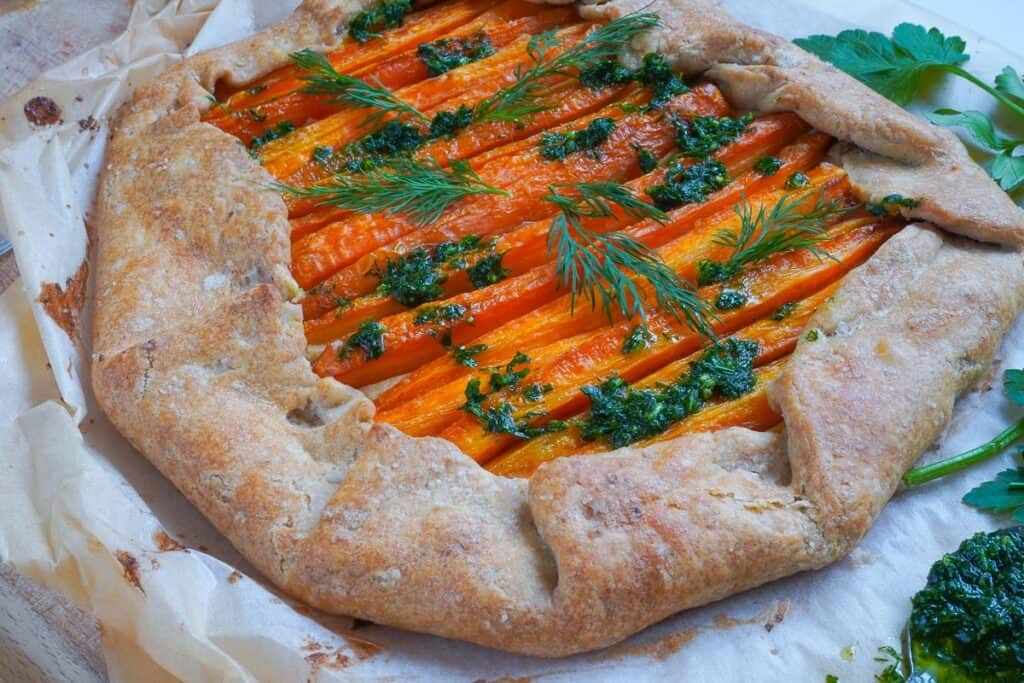 rustique carrot tart close hot with a green herb pesto